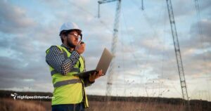 Worker holding radio by power line