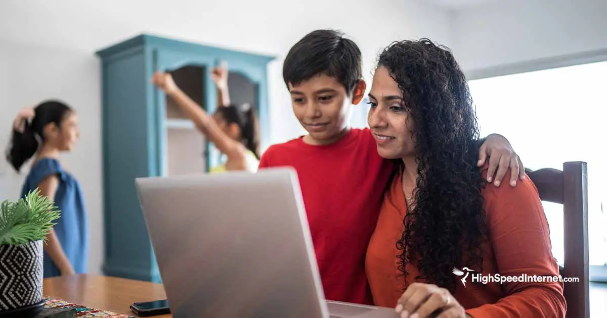 Mother and son looking at laptop screen